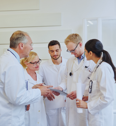 A team of doctors is reviewing a diagnosis on a paper